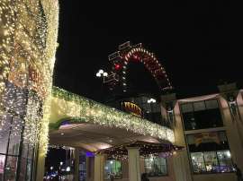 Der weihnachtlicher illuminierte Eingang zum Riesenradplatz, im Hintergrund das Riesenrad