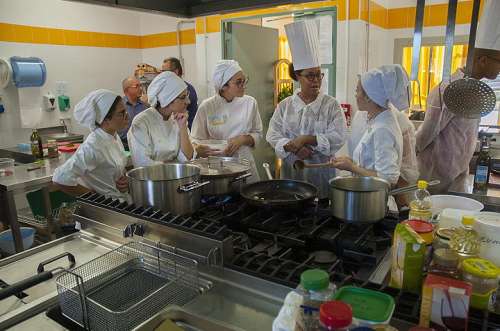 Culinary specialists attached to U.S. Navy Medicine and Readiness Training Command Sigonella conduct a community relations project with Sicilian culinary students for the purposes of cultural and occupational exchange.